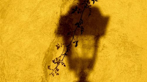 Lantern shadow on a yellow wall HD Wallpaper