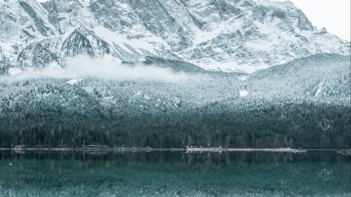 Mountain reflection at an icy lake HD Wallpaper
