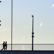 Silhouette walking at a bridge HD Wallpaper