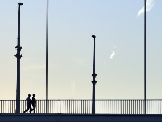 Silhouette walking at a bridge HD Wallpaper