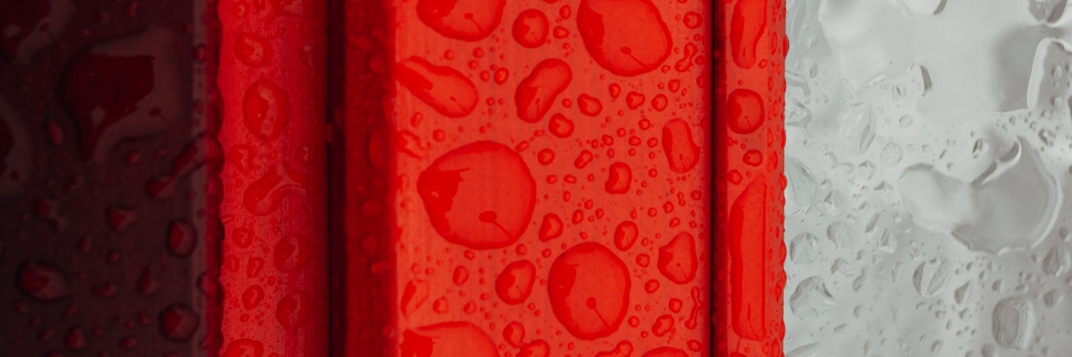 Water drops on a red and grey surface HD Wallpaper